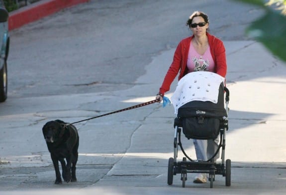 Multitasking new mommy Minnie Driver takes both her baby Henry and dog for a walk