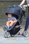 Miranda Kerr carries a very happy looking Flynn Bloom as they head home after a stroll through Central Park in New York