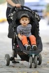 Miranda Kerr carries a very happy looking Flynn Bloom as they head home after a stroll through Central Park in New York