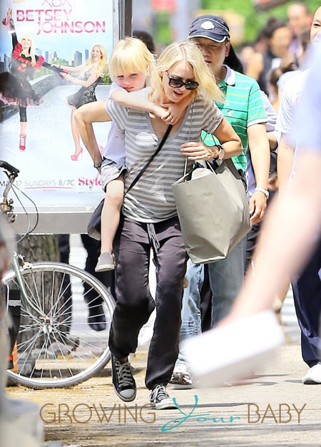 Samuel Kai lays on his mother, Naomi Watts, lap while she chats on her cell phone in NYC