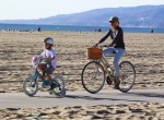 Naomi Watts bikes at the beach with her son Sammy