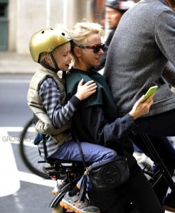 Naomi Watts on a bike withs on Sasha and partner Liev Schreiber