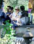 Samuel Kai lays on his mother, Naomi Watts, lap while she chats on her cell phone in NYC