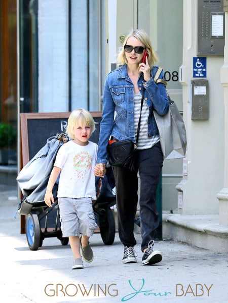 Samuel Kai lays on his mother, Naomi Watts, lap while she chats on her cell phone in NYC