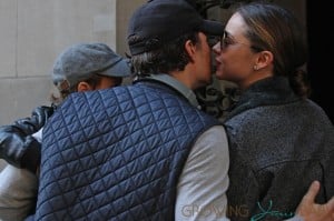Orlando Bloom and Miranda Kerr kiss after a walk with their son Flynn