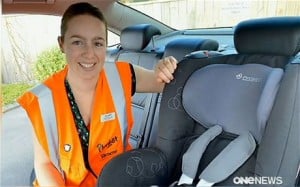 Plunket staff fitting a Maxi-Cosi baby seat into the official car that will transport the royal visitors