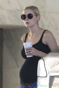 Jaime King shows off her growing baby bump in a black tank top as she makes a stop at a Coffee Bean in Los Angeles