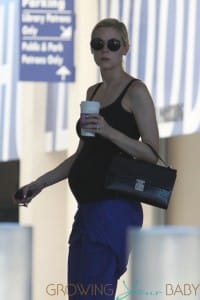 Jaime King shows off her growing baby bump in a black tank top as she makes a stop at a Coffee Bean in Los Angeles