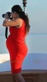 Kim Kardashian shows off her bump in tight red dress on board a yacht with Kourtney Kardashian in Greece