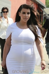 Kim Kardashian shows off her growing pregnancy curves in a form-fitting white dress as she and mom Kris Jenner head out of Stanley's in Los Angeles