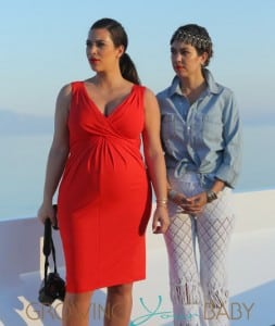 Kim Kardashian shows off her bump in tight red dress on board a yacht with Kourtney Kardashian in Greece