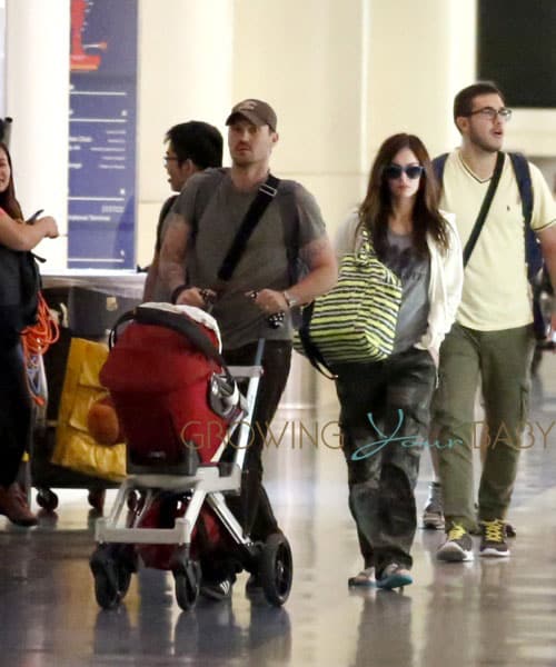 A pregnant Megan Fox shows off a slight baby bump at LAX