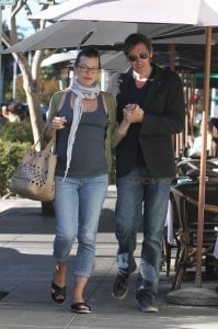 Milla Jovovich showing off a large baby bump in a tight tank top as she and her husband Paul W