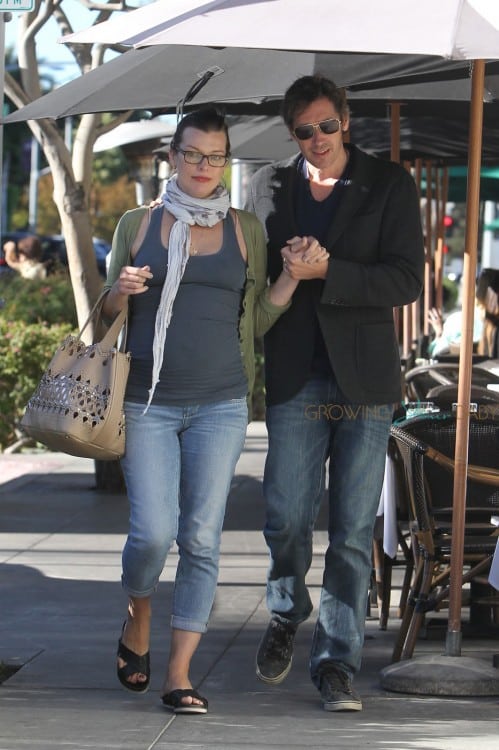 Milla Jovovich showing off a large baby bump in a tight tank top as she and her husband Paul W.S. Anderson walk back to their car after having lunch at La Scala in Beverly Hills