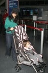 Salma Hayek pushes her daughter Valentina in a Juicy Couture baby stroller through JFK airport in New York