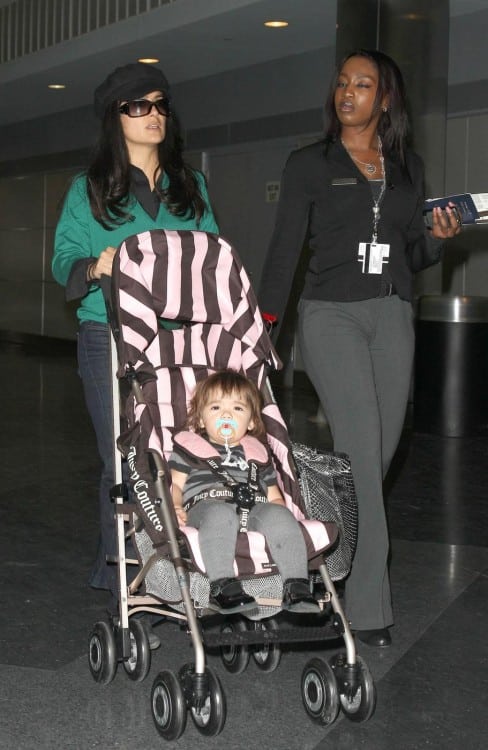 Salma Hayek pushes her daughter Valentina in a Juicy Couture baby stroller through JFK airport in New York