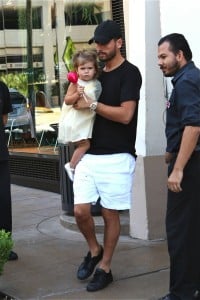 Scott Disick carries daughter Penelope out of an American Girl Party