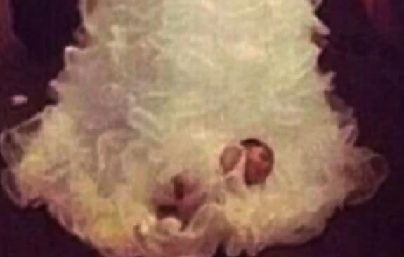 Shona Carter-Brooks infant tied to wedding dress