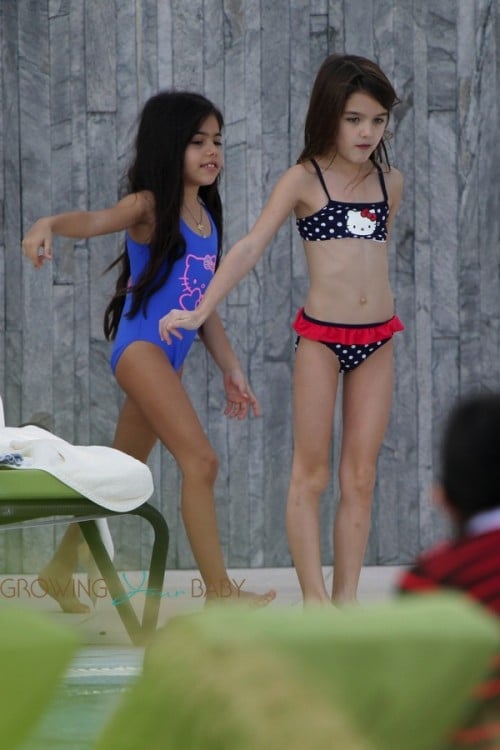 Suri Cruise dances poolside in Miami with a friend