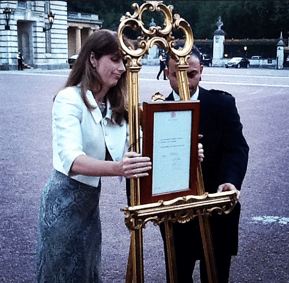 The Queen's Press Secretary and a footman post the official announcement of the birth of The Duke and Duchess of Cambridge's baby on an easel in Buckingham Palace forecourt