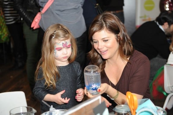 Tiffani Thiessen with her daughter at the Secret Santa Workshop