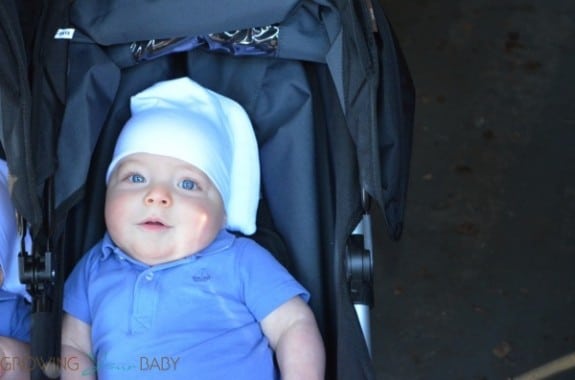 Wearing a Tortle cap in the stroller