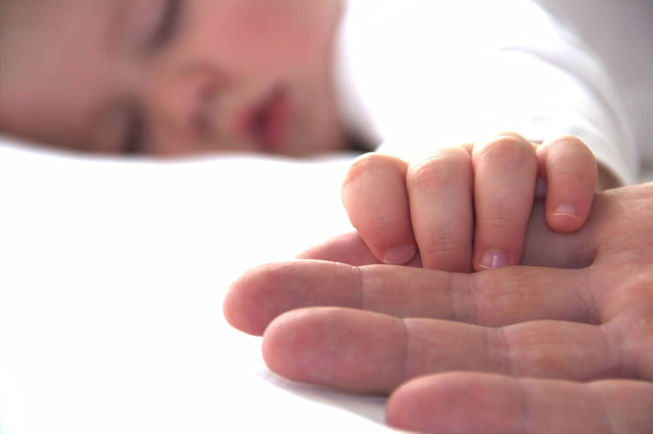 baby sleeping with parent