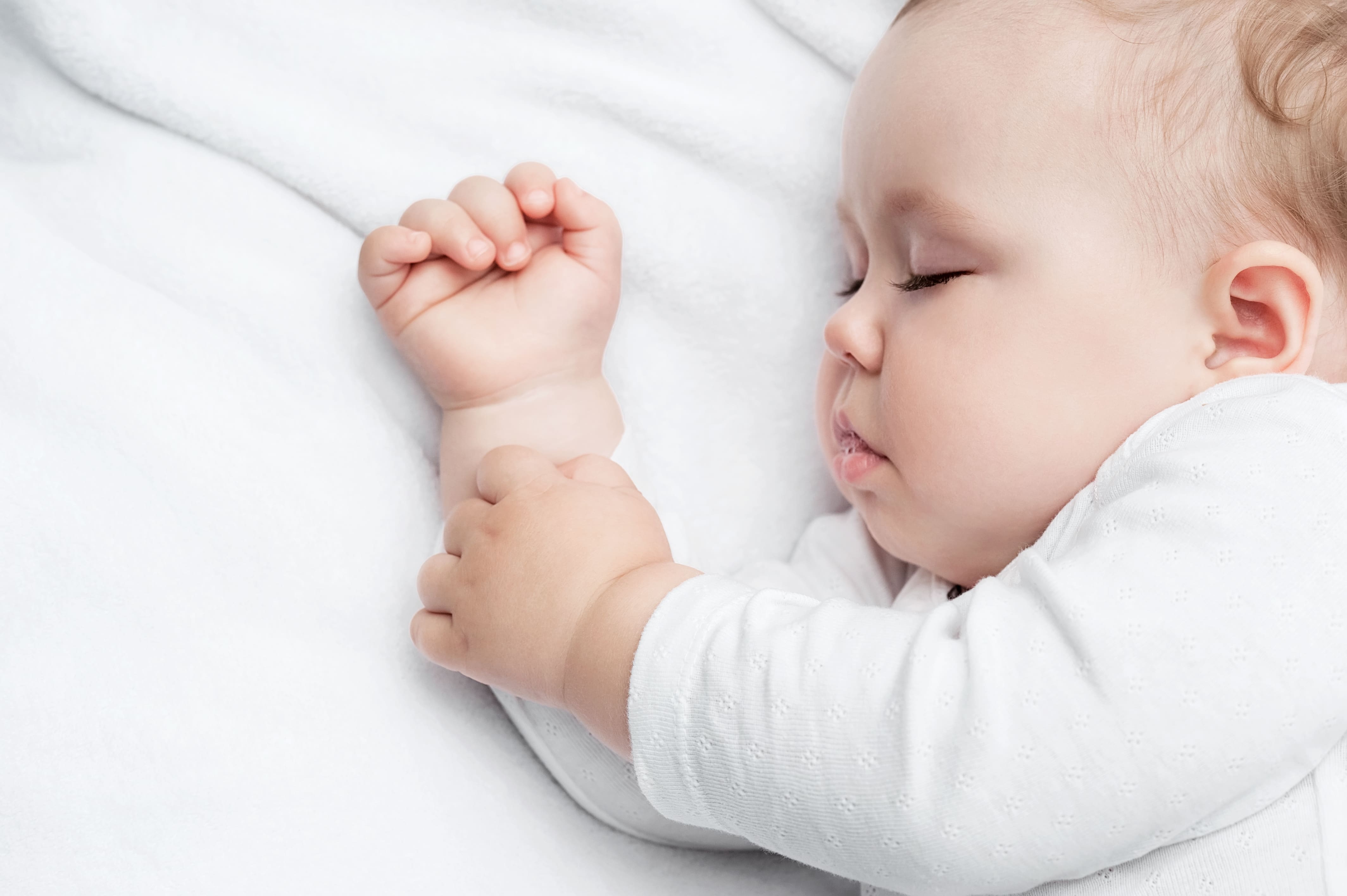 Carefree sleeping little baby on a bed