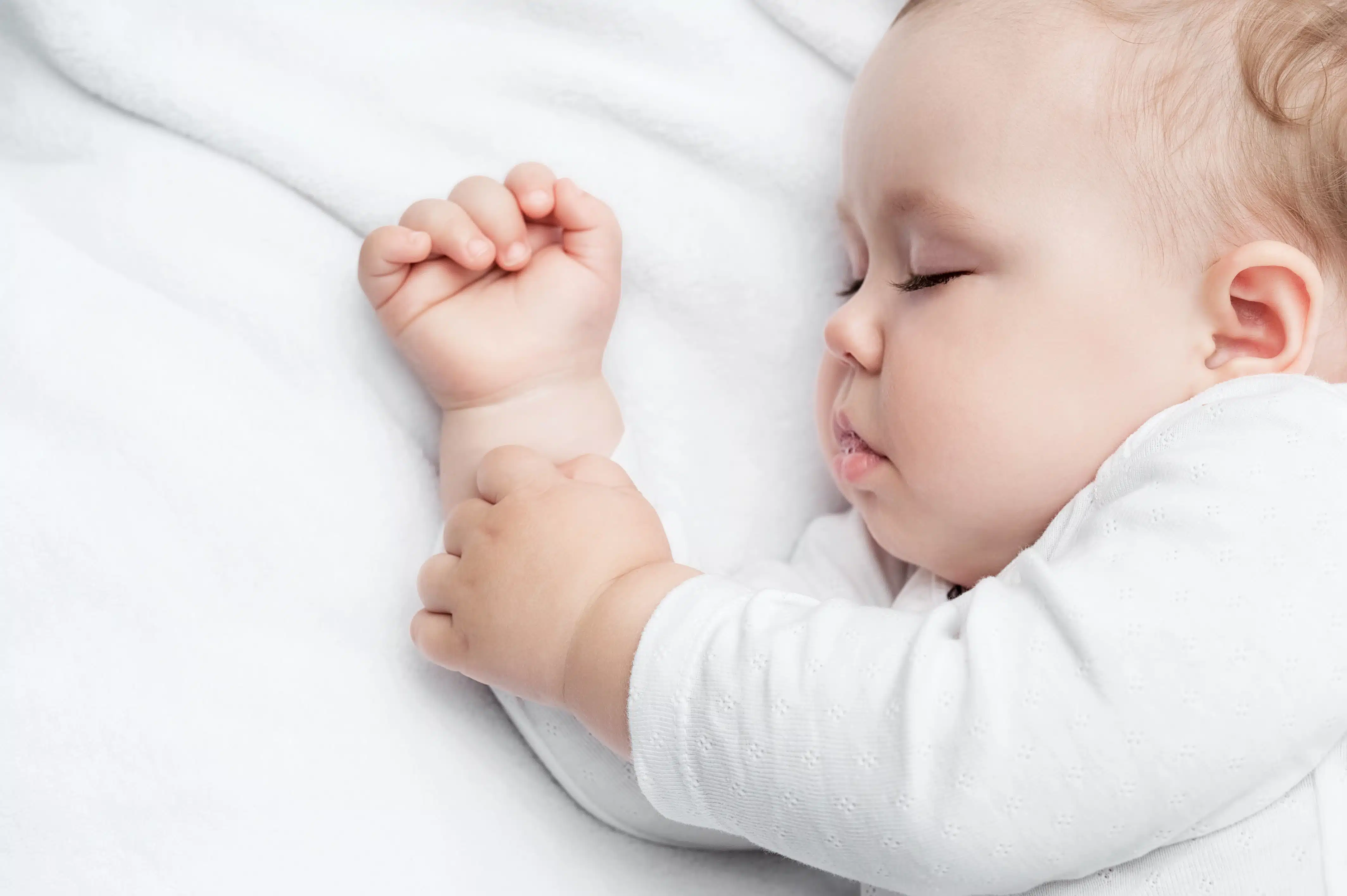 Carefree sleeping little baby on a bed