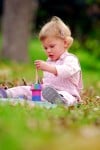 child playing with Tinocchio wooden stacker