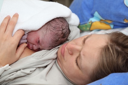 Newborn baby with mother minutes after the birth