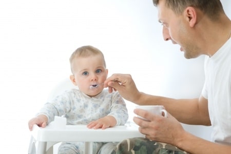 dad feeding baby