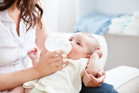 infant drinking a bottle