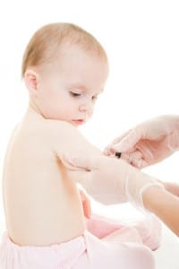 The doctor makes a baby vaccination on a white background.