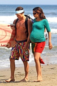**EXCLUSIVE**RESTRICTIONS APPLY: Matthew McConaughey is met by his heavily pregnant girlfriend Camila Alves and a refreshing beer after surfing in Malibu on Independence Day