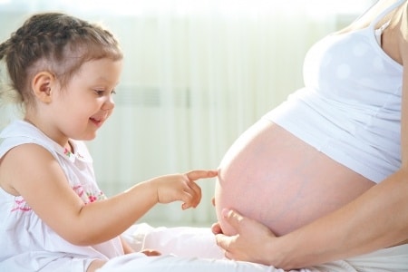 pregnant mom with her daughter